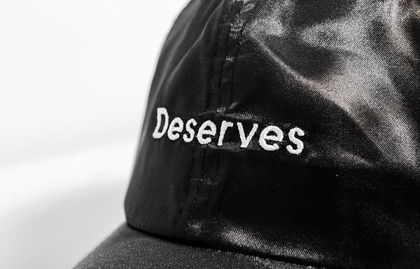 'Deserves' Buckle Black Cap